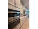 Modern kitchen with stainless steel appliances, sleek cabinets, and hardwood floors at 2920 Agostino Ter, Kissimmee, FL 34746