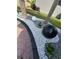 Landscaping with gravel, rocks, tropical plants, and decorative water feature enhance the curb appeal at 2920 Agostino Ter, Kissimmee, FL 34746