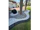 Close up of the decorative landscaping featuring sculpted rocks, white pebbles and green foliage at 2920 Agostino Ter, Kissimmee, FL 34746