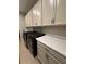Well-equipped laundry room with modern washer and dryer, storage cabinets, and countertop space at 2920 Agostino Ter, Kissimmee, FL 34746