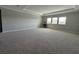 Spacious living room with carpet and a tray ceiling at 2920 Agostino Ter, Kissimmee, FL 34746