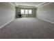 Large living room area with neutral walls and carpet at 2920 Agostino Ter, Kissimmee, FL 34746