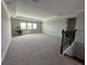 Bright living room featuring a tray ceiling and staircase at 2920 Agostino Ter, Kissimmee, FL 34746
