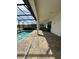 Relax and unwind on the covered patio, steps away from a screened-in pool with tranquil lake views at 2920 Agostino Ter, Kissimmee, FL 34746