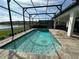 Screened in pool area with a water fountain feature and comfortable outdoor seating at 2920 Agostino Ter, Kissimmee, FL 34746