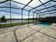 Screened pool enclosure overlooking a serene pond, perfect for relaxation and outdoor enjoyment at 2920 Agostino Ter, Kissimmee, FL 34746