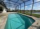 Sparkling pool with screen enclosure offering serene lake views, ideal for outdoor enjoyment at 2920 Agostino Ter, Kissimmee, FL 34746