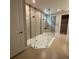 A glass shower with dual shower heads and decorative tile accents, showcasing a modern and spacious bathroom feature at 2920 Agostino Ter, Kissimmee, FL 34746