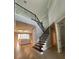 Elegant staircase with wood and iron railings, leading to an open living space, enhancing the home's design at 2920 Agostino Ter, Kissimmee, FL 34746