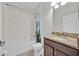 Bright bathroom featuring a shower-tub combo, a vanity with a granite countertop, and ample lighting at 2985 Banana Palm Dr, Kissimmee, FL 34747