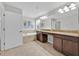 Neutral bathroom boasts double sinks with granite countertops and a soaking tub at 2985 Banana Palm Dr, Kissimmee, FL 34747