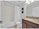 Full bathroom with tub and shower combination and granite topped vanity at 2985 Banana Palm Dr, Kissimmee, FL 34747