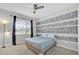 Comfortable bedroom with a ceiling fan and a window that provides natural light and pleasant outdoor views at 2985 Banana Palm Dr, Kissimmee, FL 34747