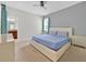 Bedroom features neutral-toned walls, carpet floors, and a comfortable bed with convenient access to the bathroom at 2985 Banana Palm Dr, Kissimmee, FL 34747