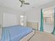 Cozy bedroom with carpet flooring, a modern bed, and a bright window at 2985 Banana Palm Dr, Kissimmee, FL 34747