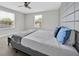 Well lit bedroom with bright windows, carpet floors, and a modern headboard at 2985 Banana Palm Dr, Kissimmee, FL 34747