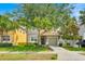 Charming two-story home features a well-manicured lawn, a two-car garage, and mature trees offering ample shade at 2985 Banana Palm Dr, Kissimmee, FL 34747