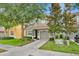 Charming two-story home features a well-manicured lawn, a two-car garage, and mature trees offering ample shade at 2985 Banana Palm Dr, Kissimmee, FL 34747