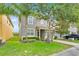 Charming two-story home features a well-manicured lawn, a two-car garage, and mature trees offering ample shade at 2985 Banana Palm Dr, Kissimmee, FL 34747