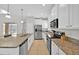 Bright kitchen features granite countertops, stainless steel appliances, a double sink, and lots of cabinets at 2985 Banana Palm Dr, Kissimmee, FL 34747