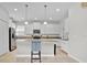 This kitchen features white cabinetry, granite countertops, stainless steel appliances, and a center island with seating at 2985 Banana Palm Dr, Kissimmee, FL 34747
