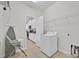 The laundry room features a washing machine, ironing board, and convenient access to the kitchen at 2985 Banana Palm Dr, Kissimmee, FL 34747