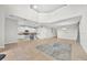 Open-concept living room flowing into kitchen, tile flooring throughout, and sliding door access to the pool area at 2985 Banana Palm Dr, Kissimmee, FL 34747