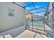 A screened-in backyard pool and spa, set against the backdrop of a well-maintained home exterior at 2985 Banana Palm Dr, Kissimmee, FL 34747
