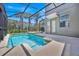 Private screened-in pool and spa area with well-maintained patio and tropical landscaping at 2985 Banana Palm Dr, Kissimmee, FL 34747