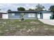 Charming single-story home with a blue exterior, manicured lawn, and attached garage at 31 S Edgemon Ave, Winter Springs, FL 32708