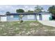 Charming single-story home with a blue exterior, manicured lawn, and attached garage at 31 S Edgemon Ave, Winter Springs, FL 32708