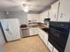 Well-lit kitchen with white cabinets, and modern appliances at 31 S Edgemon Ave, Winter Springs, FL 32708