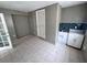 Spacious tiled laundry room featuring white cabinetry, a sink, and ample floor space for convenience at 31 S Edgemon Ave, Winter Springs, FL 32708