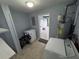 Laundry area featuring multiple washers, a dryer, and a water heater, offering convenience and functionality at 31 S Edgemon Ave, Winter Springs, FL 32708