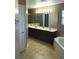 Primary bathroom featuring a double vanity, shower, and soaking tub at 3102 Westbrook Rd, Kissimmee, FL 34746