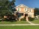 Two-story home featuring well-maintained lawn, neatly trimmed hedges, and classic shutters at 3102 Westbrook Rd, Kissimmee, FL 34746