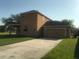 Two-story home with a two car garage and driveway at 3102 Westbrook Rd, Kissimmee, FL 34746