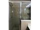 Bathroom shower featuring glass enclosure and tiled walls at 3102 Westbrook Rd, Kissimmee, FL 34746