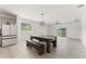 Spacious dining area with modern table, bench seating, and lots of natural light at 33263 Rembrandt Ln, Sorrento, FL 32776