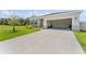 Charming single-story home with a large driveway, an attached garage, and well-maintained landscaping at 33263 Rembrandt Ln, Sorrento, FL 32776