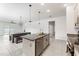Bright kitchen open to the dining area, featuring granite countertops and stainless steel appliances at 33263 Rembrandt Ln, Sorrento, FL 32776
