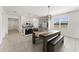 Open kitchen and dining area featuring stainless steel appliances and stylish light fixtures at 33263 Rembrandt Ln, Sorrento, FL 32776