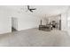 Open-concept living room adjacent to the kitchen and dining area with ceramic tile flooring at 33263 Rembrandt Ln, Sorrento, FL 32776