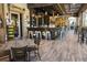 Relaxing bar area with a rustic design, multiple stools, pendant lights, and plank flooring at 349 Captiva Dr, Davenport, FL 33896