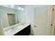 Bright bathroom featuring a dual vanity, granite countertops, and a large mirror at 349 Captiva Dr, Davenport, FL 33896