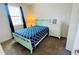 Well lit bedroom with carpet, closet, dresser, and a blue patterned bedspread at 349 Captiva Dr, Davenport, FL 33896