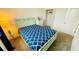Well lit bedroom with carpet, closet, accent table, and a blue patterned bedspread at 349 Captiva Dr, Davenport, FL 33896