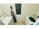Efficient laundry room featuring a washer, dryer, ironing board and electric panel for convenience at 349 Captiva Dr, Davenport, FL 33896
