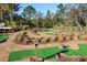 Well-maintained miniature golf course with manicured greens, brick accents, and beautiful landscaping at 349 Captiva Dr, Davenport, FL 33896