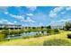 Scenic view of a community pond surrounded by lush landscaping, with townhomes in the background at 349 Captiva Dr, Davenport, FL 33896